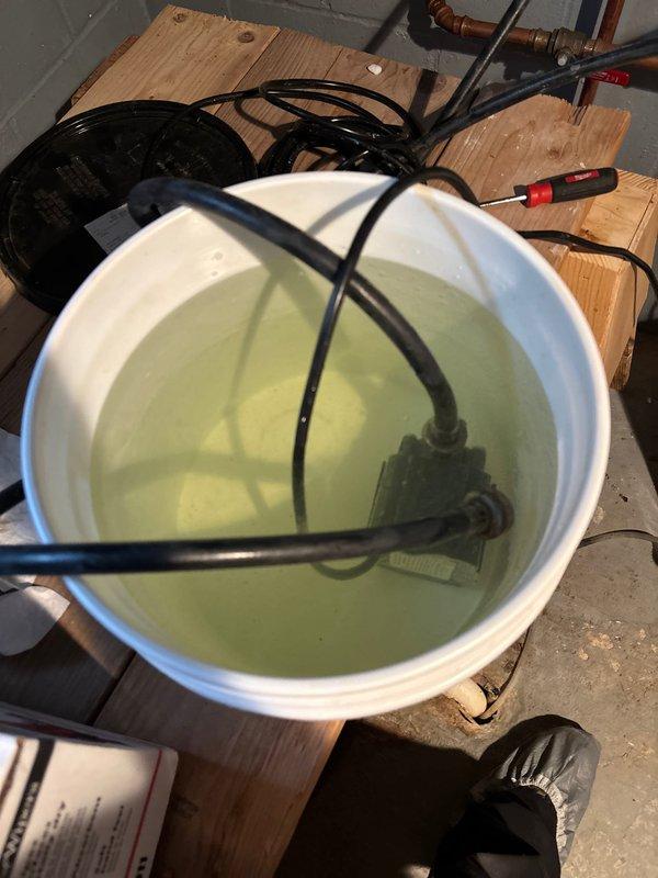 Responded to service call for Navien tankless water heater experiencing intermittent cold water delivery with unpredictable occurrence patterns. Unit had not been serviced since installation approximately 1-2 years prior. Upon inspection, performed complete descaling flush of heat exchanger using submersion pump and descaling solution to remove mineral buildup causing flow sensor irregularities and heat exchanger blockage. Opened unit's front access panel to inspect internal components, circuit boards, and heat exchanger condition. Flushed system thoroughly to restore proper water flow and consistent temperature delivery, resolving the cold water issue caused by scale accumulation on heating elements.
