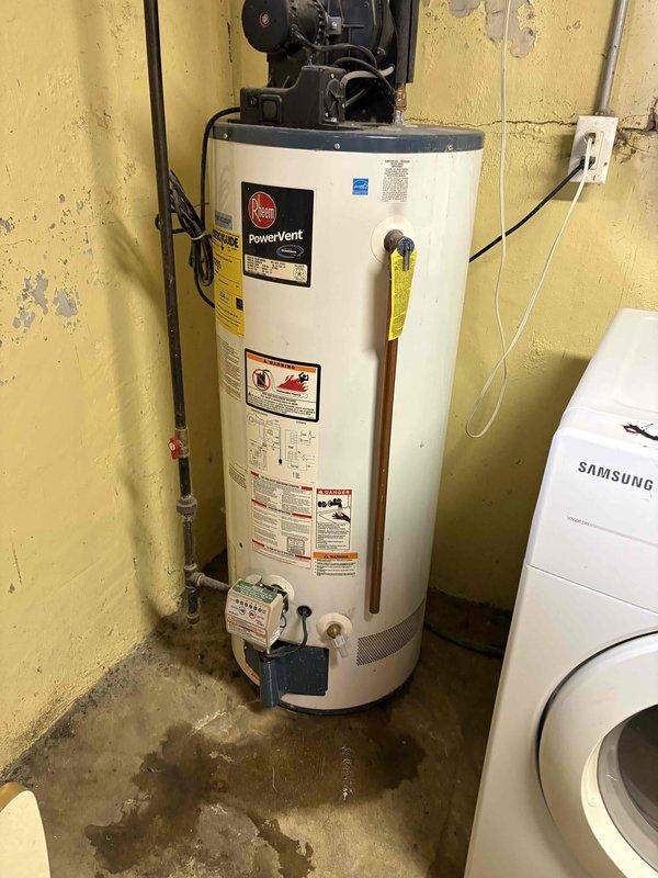 Completed annual cooling maintenance on 15-year-old Lennox air conditioning system with condenser manufactured in 2017. Inspected condensate pump operation in basement mechanical room and verified proper drainage function; documented water heater and utility room conditions showing normal wear patterns and minor moisture staining on concrete floor near equipment.