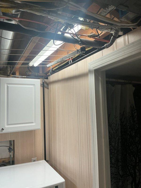 Completed gas line rework in residential laundry area, relocating and securing copper gas piping with proper safety marking behind washing machine installation. Accessed and modified overhead utility routing through ceiling infrastructure to ensure code-compliant clearances and safe appliance operation.
