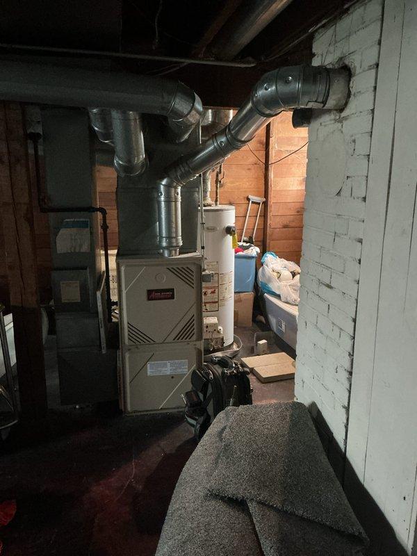 Responded to no hot water complaint on 16-year-old residential water heater. Upon inspection, found unit had reached end of serviceable life with significant sediment accumulation on top surface and aged plumbing connections showing mineral deposits and oxidation. Documented existing installation configuration including copper supply lines, pressure relief valve, and venting system in basement mechanical room. Customer advised of unit age and condition.
