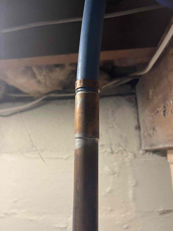 Conducted tankless water heater estimate at residential property. Inspected existing plumbing infrastructure in crawl space, documenting current water heater installation including copper supply lines, mechanical components, and structural mounting locations. Photographed existing piping configuration showing transitions between different pipe materials and assessed accessibility for potential tankless unit installation. Provided comprehensive estimate for tankless water heater replacement considering existing plumbing layout and necessary modifications.