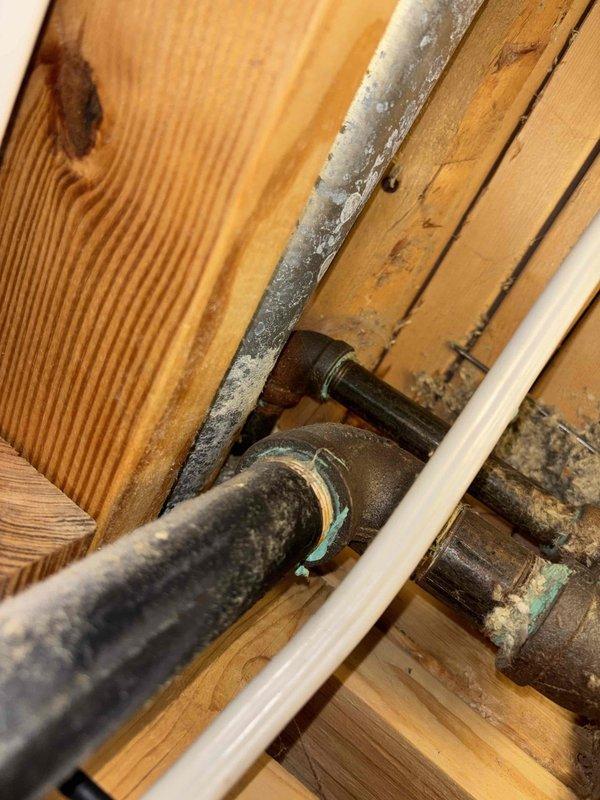 Responded to plumbing repair request for severely corroded gas line elbow and adjacent vent pipe that were making contact. Replaced rusted gas line elbow fitting and corroded vent pipe section, ensuring proper clearance between components to prevent future contact and corrosion issues. Verified all connections were secure and system operating safely upon completion.