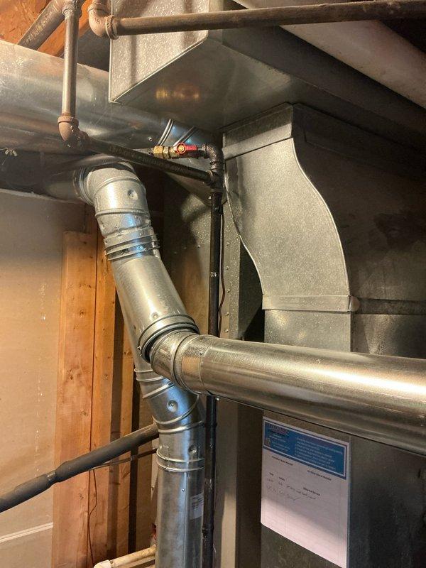 Performed comprehensive inspection of 28-year-old Nordyne furnace and air conditioning system currently in operational condition. Documented existing HVAC installation including furnace, air handler, ductwork configuration, and associated mechanical components in basement utility area. Provided detailed estimate for complete system replacement package including new furnace and AC unit to address aging equipment and improve energy efficiency.