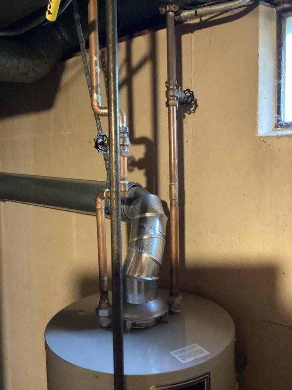 Responded to no hot water complaint on approximately 13-year-old residential water heater. Upon inspection, determined unit had reached end of serviceable life and was no longer producing hot water. Documented existing installation including copper supply lines, expansion tank, and venting configuration for customer records.