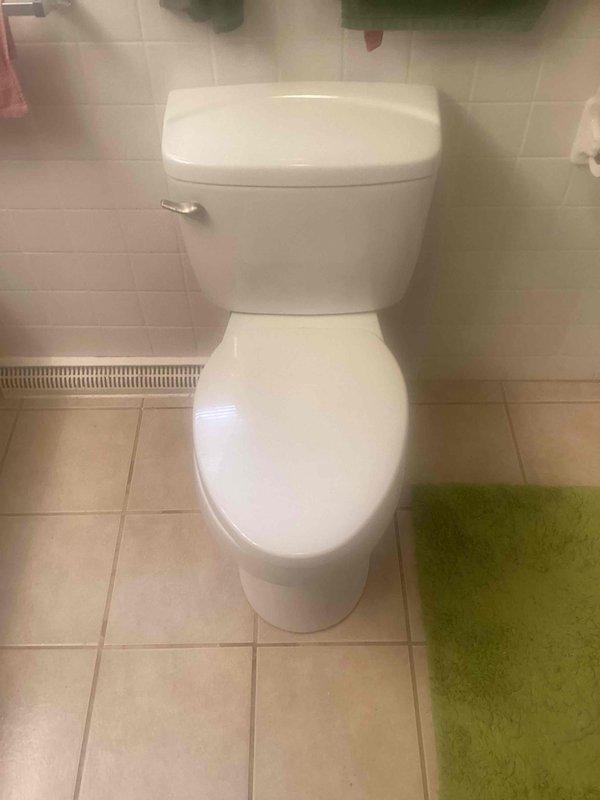 Responded to toilet flushing issue at residential property. Upon inspection, found aging flush valve assembly with worn flapper and compromised chain connection causing incomplete or irregular flushing cycles. Tank interior showed significant mineral deposits and water staining consistent with hard water conditions affecting component performance. Inspected fill valve assembly with float mechanism, which appeared functional but showed signs of age-related wear. Documented tank conditions including sediment buildup on interior surfaces. Photographed internal tank components and exterior toilet installation for service records. Recommended tank component replacement or adjustment to restore proper flushing function and prevent future performance issues.