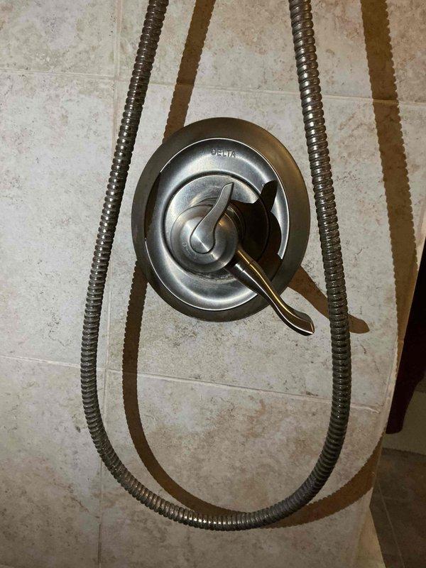 Responded to service call for two leaking shower faucets and outdoor spigot evaluation. Repaired Delta shower valve assemblies experiencing handle leaks in bathroom shower system. Assessed outdoor hose bib and provided repair recommendations versus replacement options. Trip charge waived for customer satisfaction purposes.