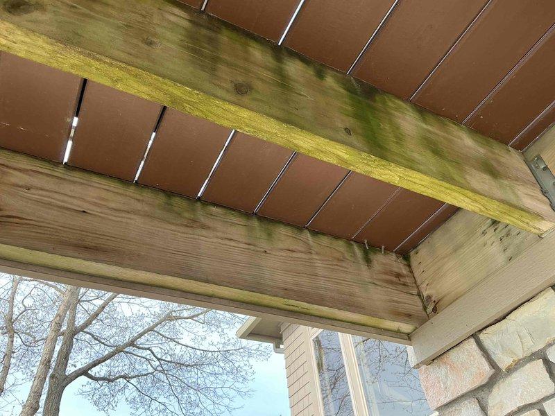 Installed new gas line from existing supply to outdoor grill location beneath covered patio structure. Routed white plastic gas tubing along wooden ceiling joists, securing properly to ensure safe and code-compliant installation for exterior cooking appliance connection.