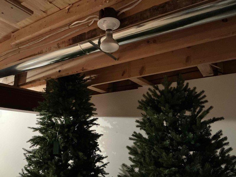 Installed new gas line from existing supply to outdoor grill location beneath covered patio structure. Routed white plastic gas tubing along wooden ceiling joists, securing properly to ensure safe and code-compliant installation for exterior cooking appliance connection.