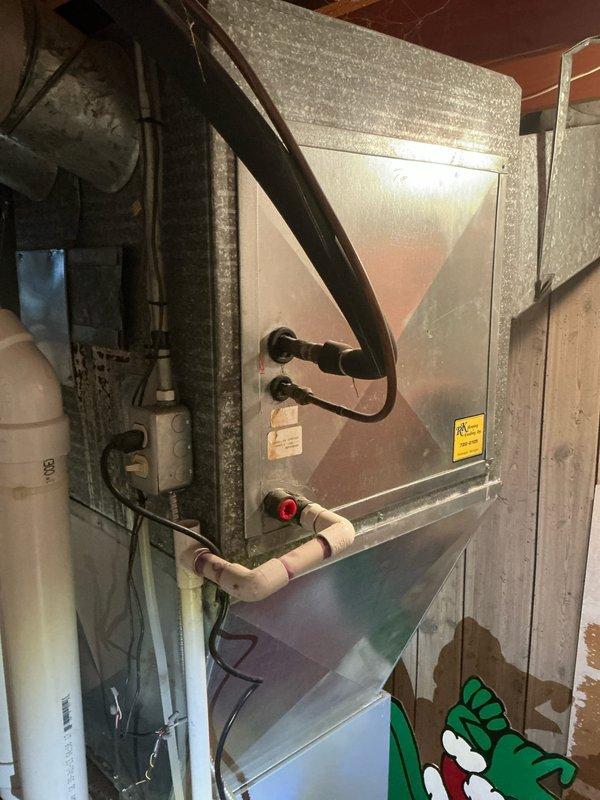 Conducted sales estimate for complete HVAC system replacement. Existing 16-year-old air handler unit located in basement utility area showing significant age-related deterioration with dust accumulation and outdated components. System reportedly failed after minimal operation following customer occupancy in 2023. Documentation revealed water damage and staining on concrete floor surrounding equipment, indicating potential condensate drainage issues or previous flooding concerns. Assessed current installation configuration including air handler, ductwork connections, and associated mechanical components to provide comprehensive replacement options for new high-efficiency system.