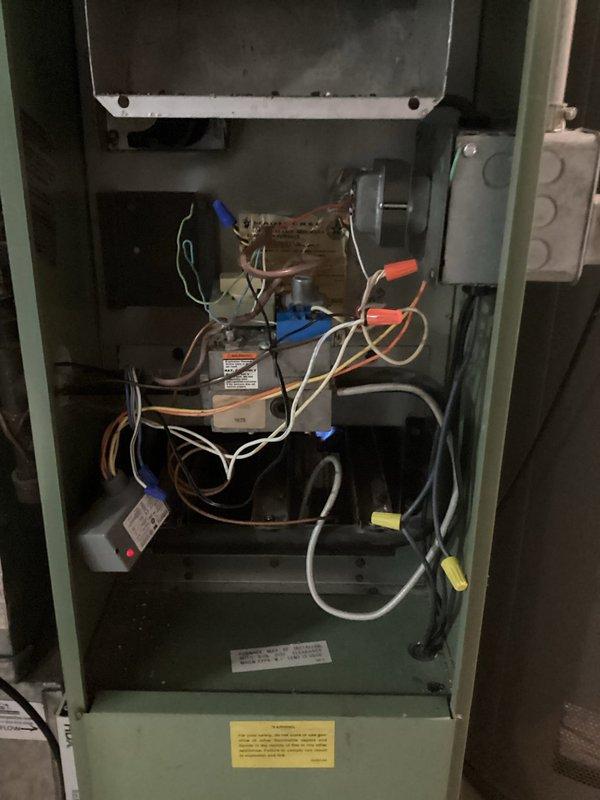 # No Cooling - System Not Starting

Responded to no cooling call on 9-year-old air conditioning system. Customer reported unit not turning on with no cold air at vents. Upon arrival, accessed air handler unit and inspected electrical components, wiring connections, and control systems. Photographed internal wiring configuration showing capacitor, wire connections, and control module for documentation. Examined condensate pump assembly and drain line system at base of unit. Performed diagnostic evaluation of HVAC system to identify cause of no-start condition and restore cooling operation.