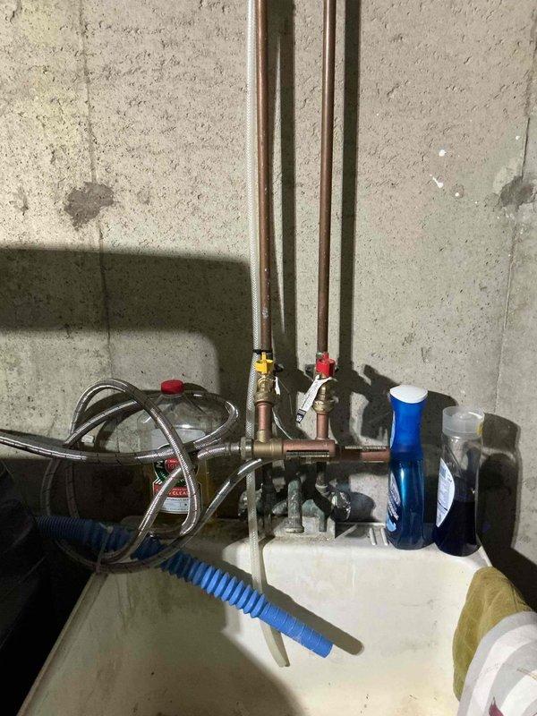 Conducted comprehensive assessment of 30-year-old residential property to provide replacement estimates for HVAC and plumbing systems. Evaluated existing furnace, air conditioner, water heater, and main water pressure regulator for replacement specifications. Inspected basement utility area where galvanized ductwork, copper supply lines, and electrical systems are exposed and accessible. Examined plumbing assembly including multiple copper pipes, ball valves with existing shutoff capabilities, and current water filtration system mounted on utility room wall. Assessed condition of existing infrastructure including oxidized copper piping, brass fittings, and flexible supply lines. Documented mechanical systems layout and spatial constraints for equipment replacement planning. Photographed existing HVAC ductwork configuration, plumbing valve arrangements, and water treatment components to develop accurate replacement specifications. Coordinated dual assessment with comfort advisor to prov