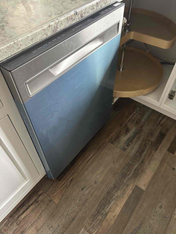 Removed existing dishwasher from under-counter installation and successfully installed customer-supplied stainless steel replacement unit. Connected dishwasher drain line to existing garbage disposal knockout and verified proper water supply connections to ensure leak-free operation and code compliance.