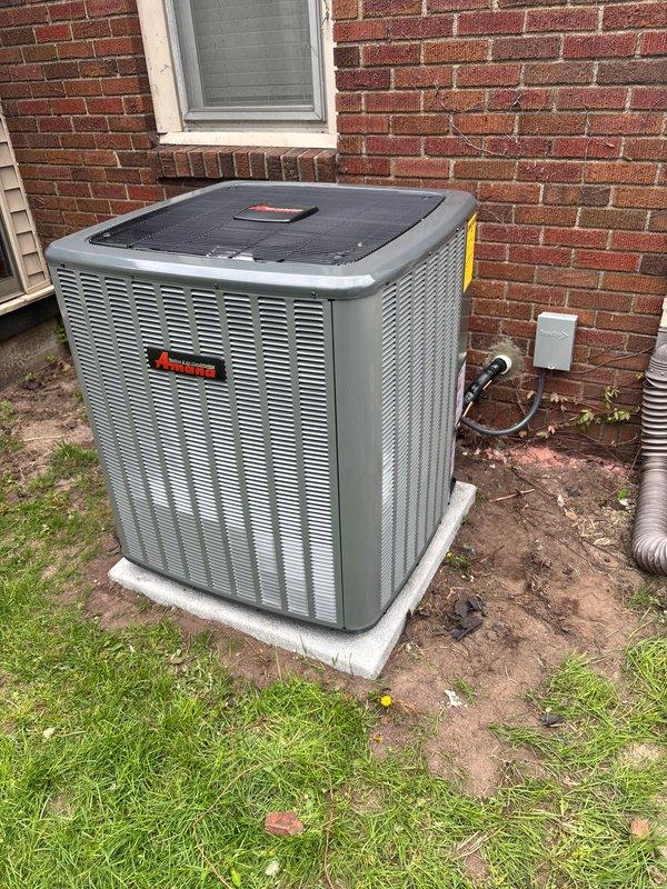 Completed full replacement of residential air conditioning system and water heater. Installed new Amana condenser unit on existing concrete pad with proper refrigerant line connections, electrical disconnect, and drainage provisions. System charged with A2L refrigerant per manufacturer specifications, with factory charge of 104 oz, field charge of 16 oz, for total system charge of 128 oz as documented on unit label.