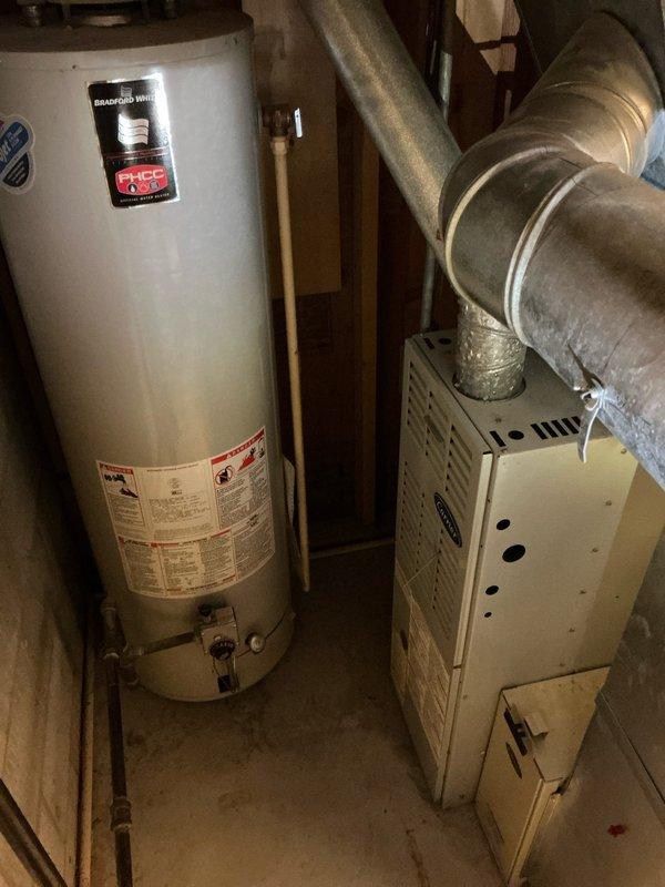 Completed comprehensive estimate for replacement of 28-year-old furnace and air conditioning system currently operational but nearing end of service life. Performed AC tune-up as part of recurring maintenance service, documenting existing equipment condition including outdoor condenser unit and indoor furnace with connected ductwork and water heater installation for customer review and system replacement planning.