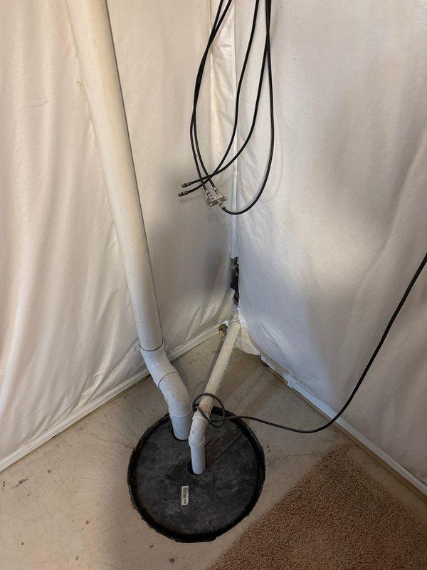 Conducted on-site assessment for backup sump pump installation in a 15-year-old residential property. Evaluated existing primary sump pump system, photographed current plumbing configuration including PVC discharge piping, electrical connections, and basin setup in basement utility area. Provided comprehensive project estimate for adding secondary backup pump system to ensure redundant drainage protection.