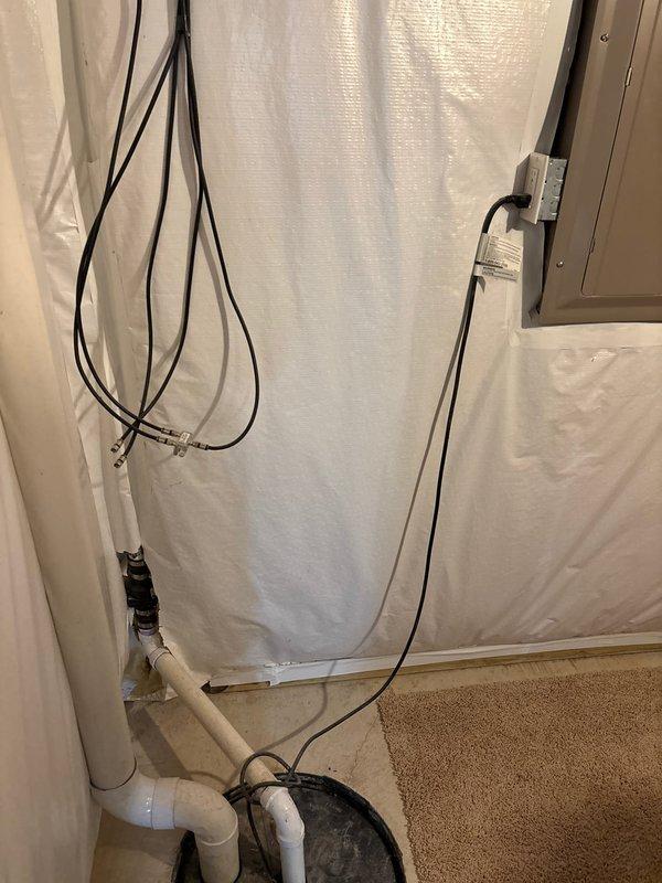 Conducted on-site assessment for backup sump pump installation in a 15-year-old residential property. Evaluated existing primary sump pump system, photographed current plumbing configuration including PVC discharge piping, electrical connections, and basin setup in basement utility area. Provided comprehensive project estimate for adding secondary backup pump system to ensure redundant drainage protection.