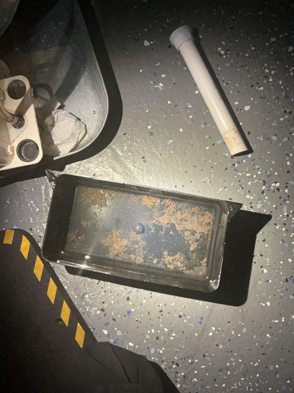 Completed annual cooling maintenance on 2011 Payne air conditioning system. Inspected and cleaned condensate drain pan and trap assembly, which showed signs of corrosion and sediment buildup. Verified proper drainage through PVC condensate line and confirmed system operational status with no immediate concerns noted.