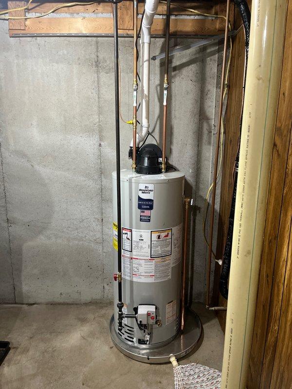 Completed full HVAC system installation including furnace, air conditioning unit, and water heater. Installed new outdoor AC condenser unit on concrete pad against exterior wall with proper electrical and refrigerant line connections. Installed new residential water heater in basement utility area with copper supply lines, PVC venting, expansion tank, and safety drip pan, ensuring all connections meet code requirements and manufacturer specifications.