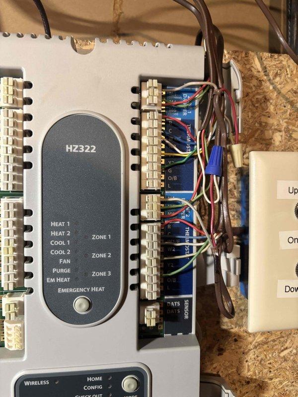 Replaced failed HVAC zone control panel with new HZ322 multi-zone controller. Installed new control board with relay switches, rewired all zone connections including heat, cool, and fan circuits for three zones, mounted step-down transformer, and verified proper operation of all heating and cooling stages across all zones.