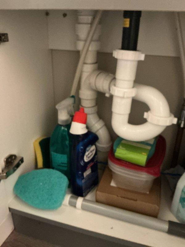 Completed full-day repipe installation for bathroom sink plumbing system. Installed new white PVC drain assembly including P-trap configuration with proper vertical and horizontal pipe connections to wall drain. All plumbing fixtures tested and verified operational upon completion.