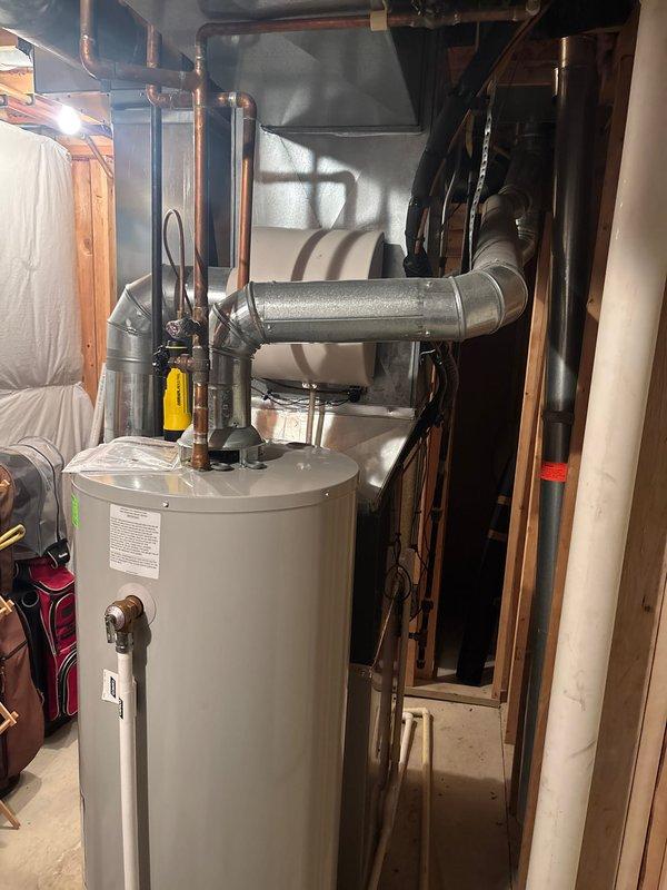 Completed full air conditioning system replacement at residential property. Installed new Amana outdoor condensing unit on concrete pad with proper electrical connections and conduit routing, established refrigerant lines, and integrated system with existing indoor air handler and ductwork in basement mechanical room. System tested and verified operational upon completion.
