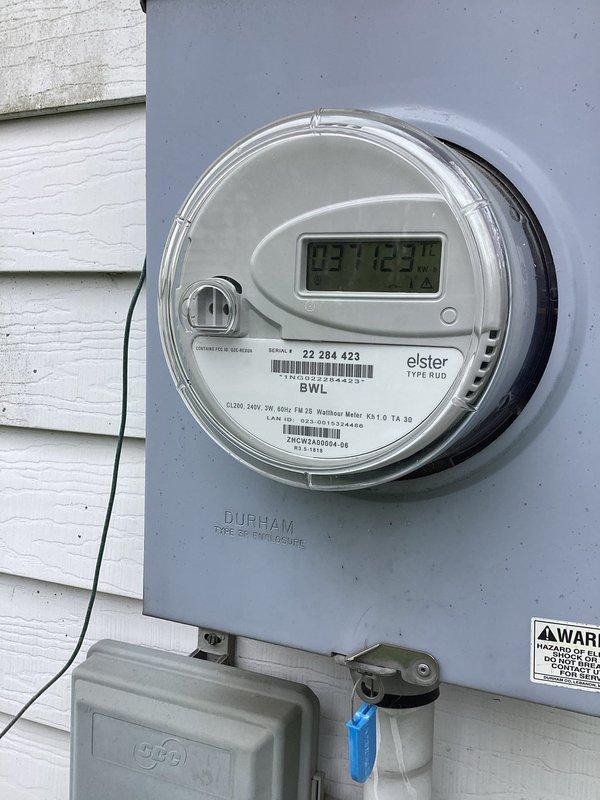Responded to client request for electrical panel upgrade to accommodate kiln installation in garage. Upon arrival, assessed existing electrical infrastructure including current panel configuration and utility meter setup. Documented existing three-panel system mounted on basement concrete block wall, consisting of main breaker box and subpanels with overhead conduit routing. Evaluated exterior meter installation (Elster Type SUO, CL200, 240V, 3W, 60Hz) to determine service capacity for required upgrade. Provided assessment and recommendations for panel upgrade necessary to support additional high-amperage kiln circuit requirements, ensuring adequate electrical capacity and code compliance for the planned garage installation.
