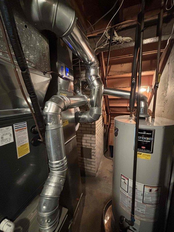 Completed annual heating and cooling maintenance on 2011 Carrier system with humidifier. Performed comprehensive furnace tune-up including burner inspection, heat exchanger examination, blower motor service, and filter replacement. Conducted air conditioning tune-up with refrigerant level check, condenser coil cleaning, and electrical connection inspection. Serviced integrated humidifier system and verified proper operation. All components tested and operating within manufacturer specifications. System photos documented for service records.