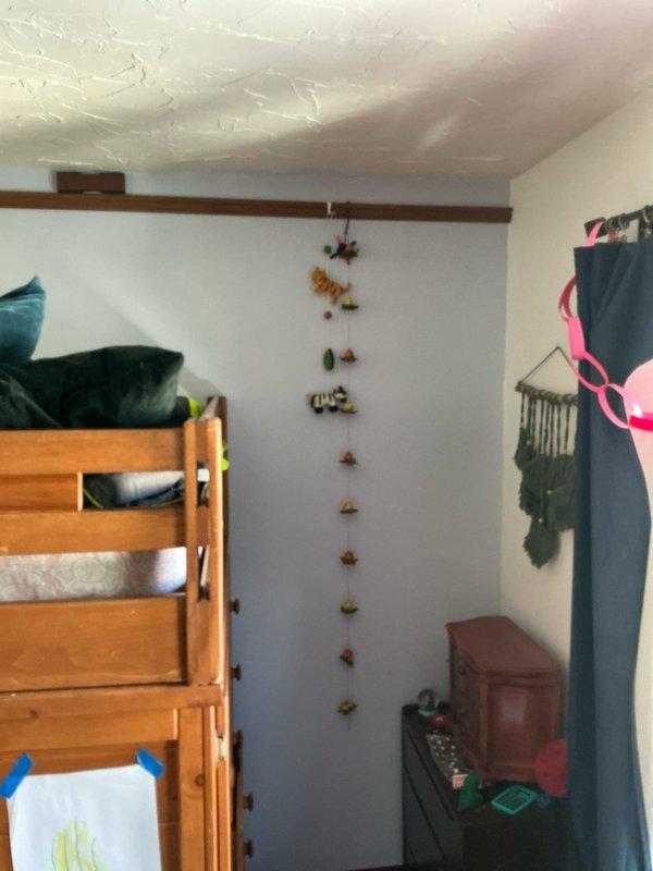 Conducted on-site assessment for ductless mini-split system installation at residential property with existing 15-year-old Comfort Maker equipment. Evaluated bedroom space and electrical infrastructure to determine appropriate zone configuration, documenting room layout and available electrical panel capacity for new system requirements.