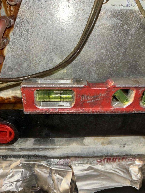 Completed annual cooling maintenance on 8-year-old Goodman system. Verified proper level and alignment of condensate drain lines using precision measuring tools, inspected PVC drainage components for proper installation and flow, and confirmed all piping connections are secure and functioning correctly to prevent water damage or drainage issues.