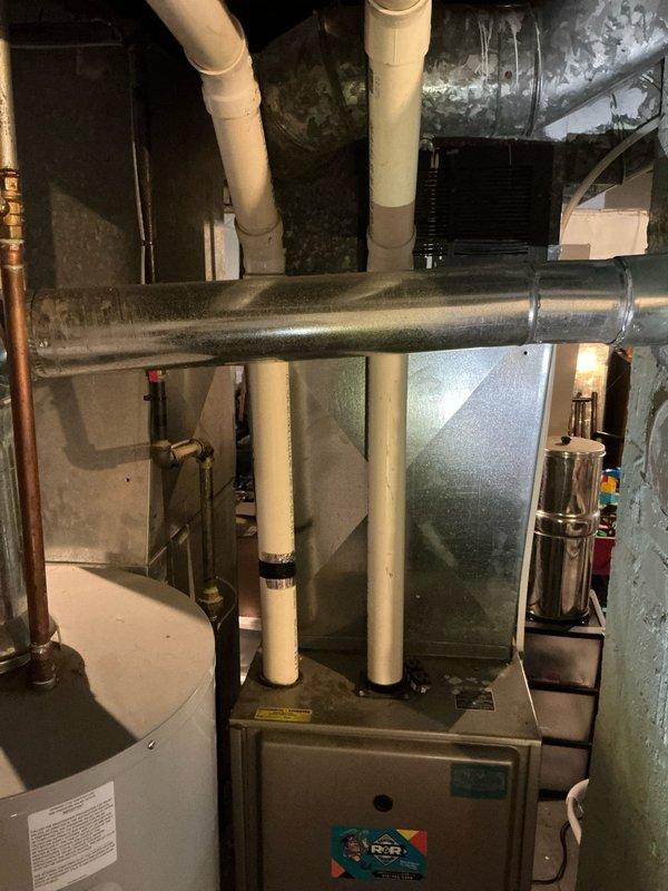 Conducted comprehensive assessment of 16-year-old furnace system for replacement estimate and new air conditioning installation. Documented existing HVAC equipment configuration in basement mechanical room, including furnace unit with vertical PVC venting, galvanized ductwork, and associated plumbing infrastructure. Provided detailed quote for complete furnace replacement and AC system installation to address aging equipment concerns.