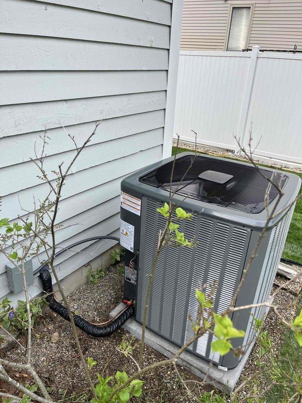 Completed full air conditioning system replacement including outdoor condensing unit and indoor air handler. New outdoor unit installed on existing concrete pad with proper clearances, condensate drainage line connected, and electrical connections verified. Indoor air handler installed in basement utility area with new ductwork connections, thermostat wiring, and refrigerant lines properly insulated and secured. System startup performed, refrigerant charge verified, airflow tested, and all safety controls confirmed operational.