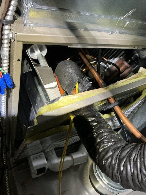 Installed evaporator freeze thermostat and low ambient kit on HVAC system. Completed electrical connections with proper wire management and verified all components functioning correctly. System tested and operational with new controls in place to prevent freeze-up conditions during low ambient temperature operation.
