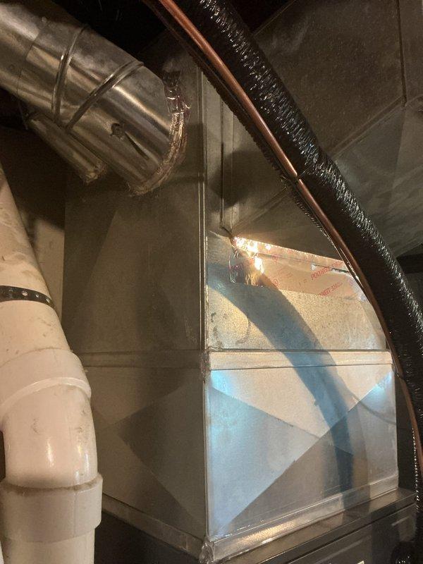 Responded to service call for persistent rattling noise from 2014 Goodman furnace that continued despite previous service attempts. Upon arrival, conducted thorough inspection of furnace and ductwork system while unit was operating normally. Identified source of rattling noise coming from supply plenum and main trunk ductwork connections. Inspected all accessible ductwork joints, seams, and metal banding in basement installation area. Tightened loose sheet metal connections and secured ductwork supports where vibration was occurring. Verified all mechanical fasteners and drive clips were properly seated. Cycled furnace through multiple heating cycles to confirm noise elimination. Unit operating within normal parameters with no abnormal sounds detected upon completion.