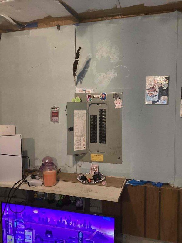 Conducted comprehensive site assessment for air conditioning system installation in basement utility area. Evaluated existing electrical infrastructure, including main breaker panel and available circuits, to determine capacity for additional AC unit. Documented current conditions of installation space, noting wall integrity, ceiling structure with exposed joists and reflective insulation, and clearance requirements for equipment placement and service access.