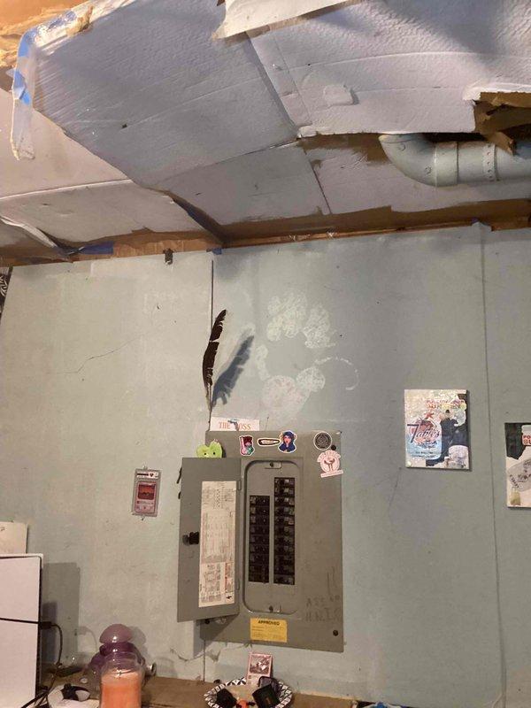 Conducted comprehensive site assessment for air conditioning system installation in basement utility area. Evaluated existing electrical infrastructure, including main breaker panel and available circuits, to determine capacity for additional AC unit. Documented current conditions of installation space, noting wall integrity, ceiling structure with exposed joists and reflective insulation, and clearance requirements for equipment placement and service access.