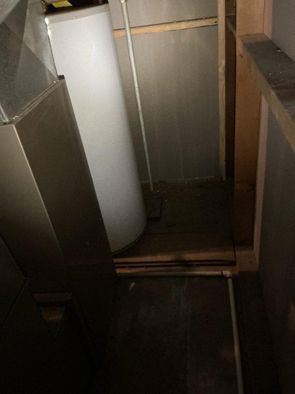 Responded to service call for water heater producing only lukewarm water and failing to maintain set temperature. Upon arrival, inspected 9-year-old residential water heater unit located in basement utility area. Performed diagnostic evaluation of heating elements, thermostat operation, and temperature settings. Assessed overall condition of unit including plumbing connections, pressure relief valve, and electrical components. Documented equipment with photos showing installation configuration, copper and galvanized piping connections, and HVAC proximity in confined utility space. Verified no active leaks present at connections or tank body. Provided customer with comprehensive assessment comparing repair options versus full unit replacement, taking into account age of existing equipment and expected service life remaining. Coordinated findings with warranty company for coverage determination and next steps.