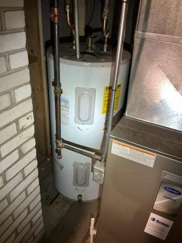 Responded to service call for water heater producing only lukewarm water and failing to maintain set temperature. Upon arrival, inspected 9-year-old residential water heater unit located in basement utility area. Performed diagnostic evaluation of heating elements, thermostat operation, and temperature settings. Assessed overall condition of unit including plumbing connections, pressure relief valve, and electrical components. Documented equipment with photos showing installation configuration, copper and galvanized piping connections, and HVAC proximity in confined utility space. Verified no active leaks present at connections or tank body. Provided customer with comprehensive assessment comparing repair options versus full unit replacement, taking into account age of existing equipment and expected service life remaining. Coordinated findings with warranty company for coverage determination and next steps.