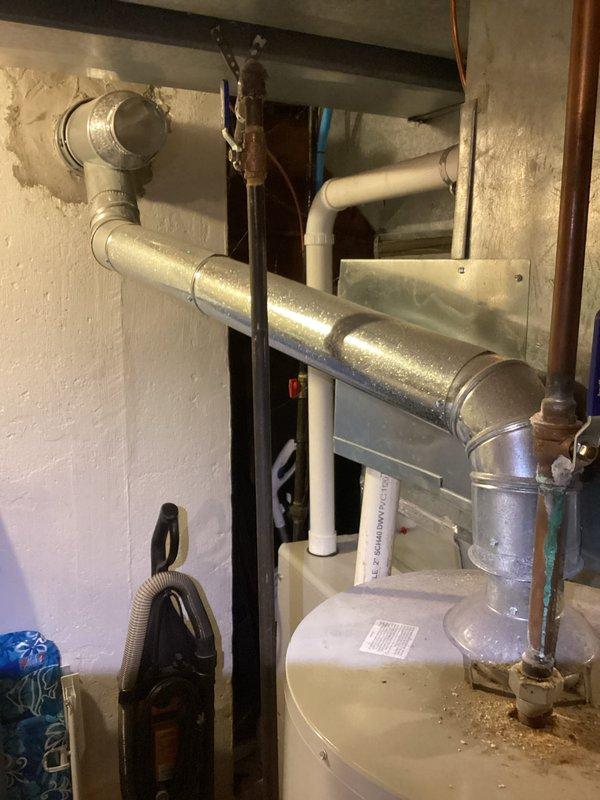 Responded to no hot water complaint on 27-year-old Bradford White water heater. Upon inspection, found unit had reached end of serviceable life with significant mineral deposit accumulation on top of tank and aging copper supply lines showing patina. Documented equipment condition with photos showing extensive frost/mineral buildup on tank top and overall plumbing configuration in mechanical room. Advised customer of water heater age and condition requiring replacement.