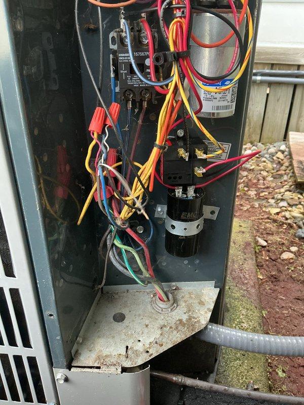 Completed annual cooling maintenance on a 9-year-old air conditioning system. Performed comprehensive inspection of outdoor condensing unit, including examination of electrical compartment components such as capacitor, contactor, and all wire connections. Documented moisture accumulation on concrete pad beneath unit and assessed overall system condition, noting normal weathering consistent with outdoor installation age. All electrical connections verified secure, and unit operational at time of service completion.