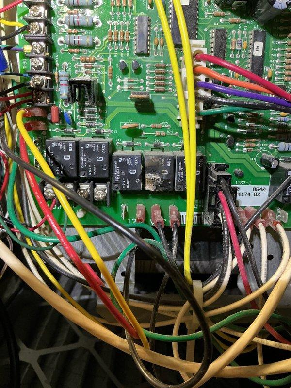 Responded to service call for burning plastic odor emanating from vents when heating system was activated following AC installation completed one week prior. Upon inspection, accessed control board assembly on 15+ year old HVAC unit to investigate odor source. Thoroughly examined printed circuit board, relays, integrated circuits, and all electrical connections for signs of overheating, damaged components, or burnt wiring. Verified all wire terminations at terminal blocks were secure and properly seated. Inspected control board components including relays, capacitors, resistors, and IC chips for visible heat damage or deterioration. Determined odor was consistent with typical burn-off of manufacturing oils and protective coatings on newly energized heating elements and electrical components that had been dormant during cooling season. Documented control board condition with photos showing all components, wiring harness, and connections in proper working order with no signs of electrica