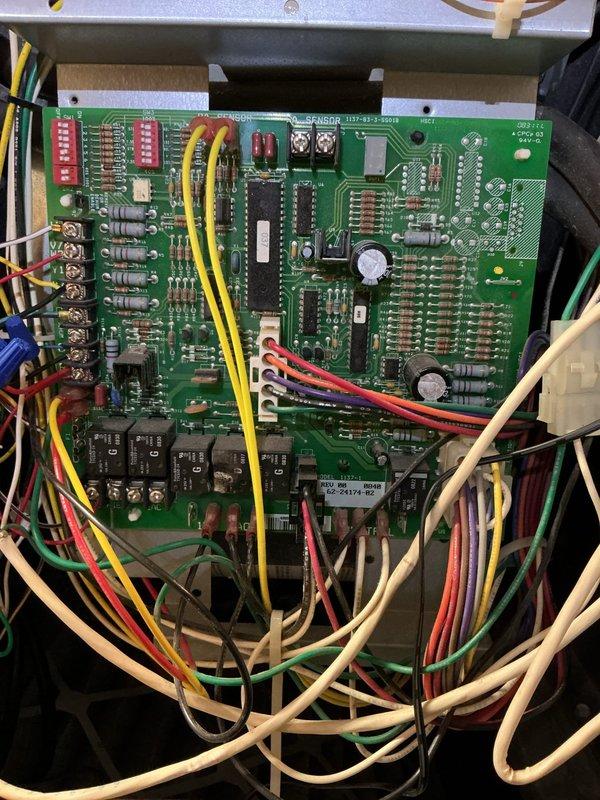Responded to service call for burning plastic odor emanating from vents when heating system was activated following AC installation completed one week prior. Upon inspection, accessed control board assembly on 15+ year old HVAC unit to investigate odor source. Thoroughly examined printed circuit board, relays, integrated circuits, and all electrical connections for signs of overheating, damaged components, or burnt wiring. Verified all wire terminations at terminal blocks were secure and properly seated. Inspected control board components including relays, capacitors, resistors, and IC chips for visible heat damage or deterioration. Determined odor was consistent with typical burn-off of manufacturing oils and protective coatings on newly energized heating elements and electrical components that had been dormant during cooling season. Documented control board condition with photos showing all components, wiring harness, and connections in proper working order with no signs of electrica