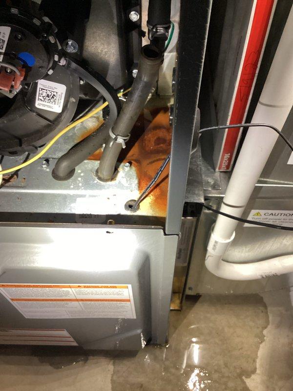 Completed annual AC tune-up on 2013 EnergiAir cooling system. During inspection, discovered water pooling at base of air handler unit and rust discoloration on metal base plate, indicating active condensate drainage issue. Documented equipment condition with photos showing compromised drain system and moisture damage to internal components. System requires condensate drain line service to prevent further water damage and potential secondary drain pan replacement.