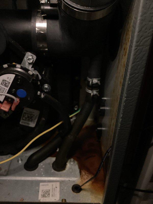 Completed annual AC tune-up on 2013 EnergiAir cooling system. During inspection, discovered water pooling at base of air handler unit and rust discoloration on metal base plate, indicating active condensate drainage issue. Documented equipment condition with photos showing compromised drain system and moisture damage to internal components. System requires condensate drain line service to prevent further water damage and potential secondary drain pan replacement.