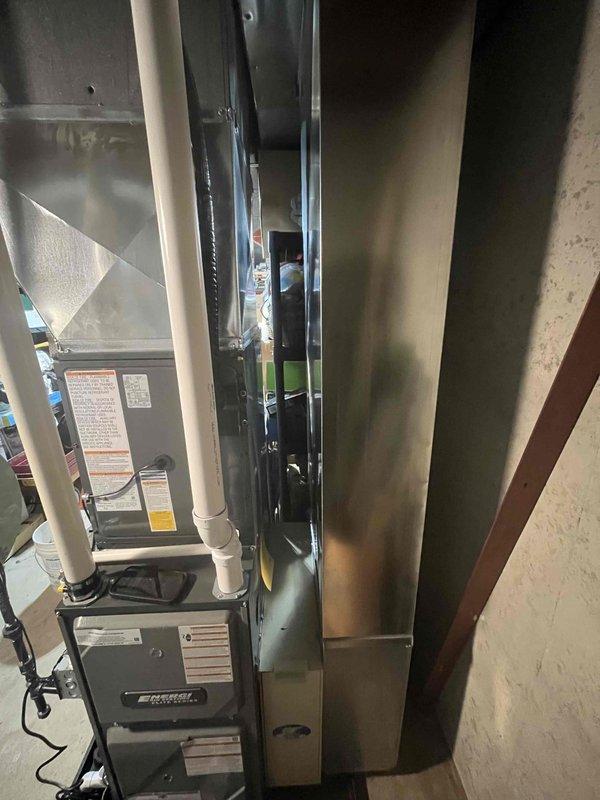 Successfully completed full HVAC system installation including new furnace and air conditioning unit in basement mechanical room. Installed furnace with proper venting using white PVC intake and exhaust piping, connected all electrical components with appropriate conduit and wiring, and fabricated galvanized sheet metal ductwork with insulated supply plenum extending to distribution system. Mounted equipment on concrete floor with proper clearances, ran condensate drainage lines, secured all connections per manufacturer specifications, and verified system operation upon completion.