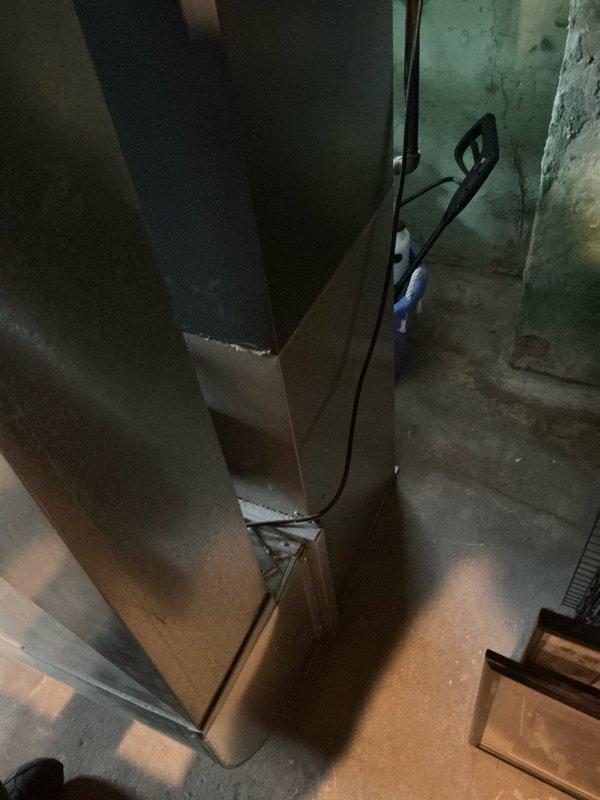 Conducted on-site assessment of non-operational furnace system in basement mechanical room. Documented existing HVAC equipment configuration including furnace unit, metal ductwork, exhaust venting with 90-degree elbow joint, and associated air handling components. Photographed current installation showing galvanized steel exhaust piping, aluminum foil-wrapped ductwork connections, copper supply lines, and insulated plenum assembly to provide comprehensive estimate for furnace replacement or repair.