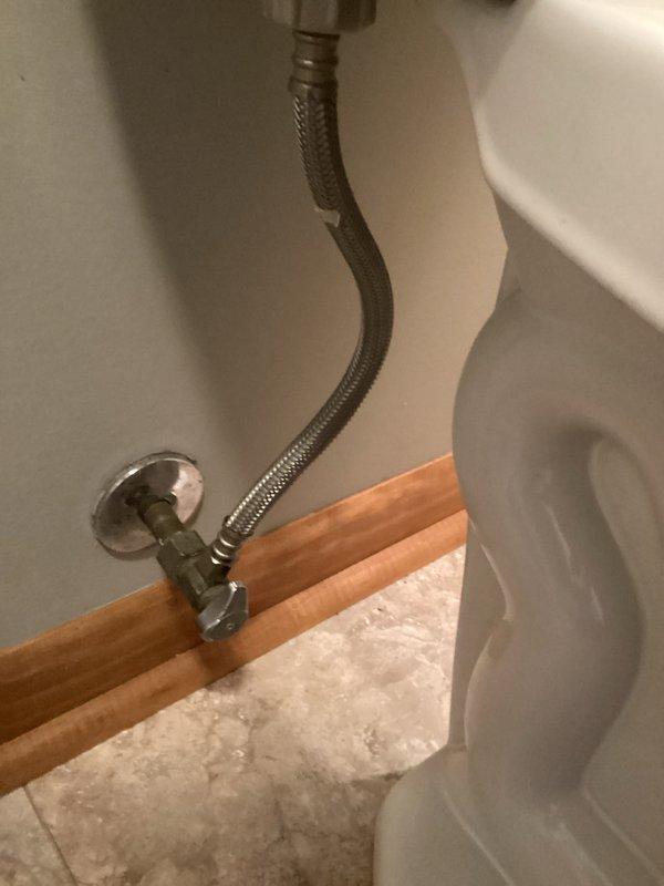 Responded to a continuously running toilet in a residential bathroom. Upon inspection, identified a worn flapper valve causing water to leak from the tank into the bowl. Replaced the defective red rubber flapper with a new unit, adjusted the chain length for proper seating, and tested the flush mechanism to ensure complete seal and proper operation. Verified the fill valve, angle stop, and braided supply line were functioning correctly with no leaks present.