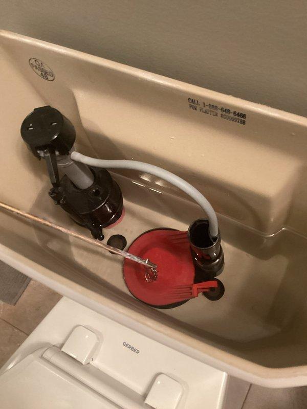 Responded to a continuously running toilet in a residential bathroom. Upon inspection, identified a worn flapper valve causing water to leak from the tank into the bowl. Replaced the defective red rubber flapper with a new unit, adjusted the chain length for proper seating, and tested the flush mechanism to ensure complete seal and proper operation. Verified the fill valve, angle stop, and braided supply line were functioning correctly with no leaks present.