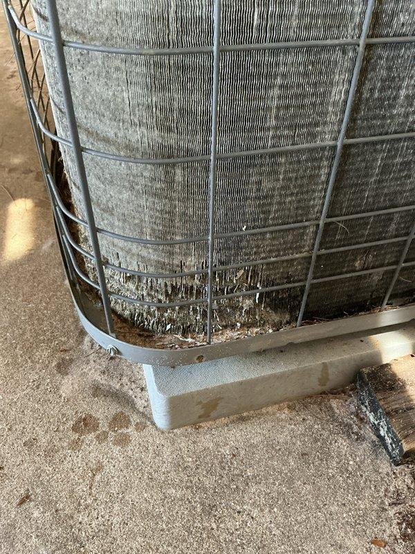 Completed annual cooling maintenance on two Heil AC systems, with the primary unit being 23 years old and the condensing unit dating to 2017. Performed comprehensive tune-up procedures including inspection of both outdoor condenser units, which showed significant dirt and debris accumulation on coil fins and protective mesh caging. Documented equipment condition with photographs showing heavy dust buildup and environmental residue on exterior surfaces, indicating extended exposure to outdoor elements without recent cleaning. Both units operational upon completion of maintenance procedures.