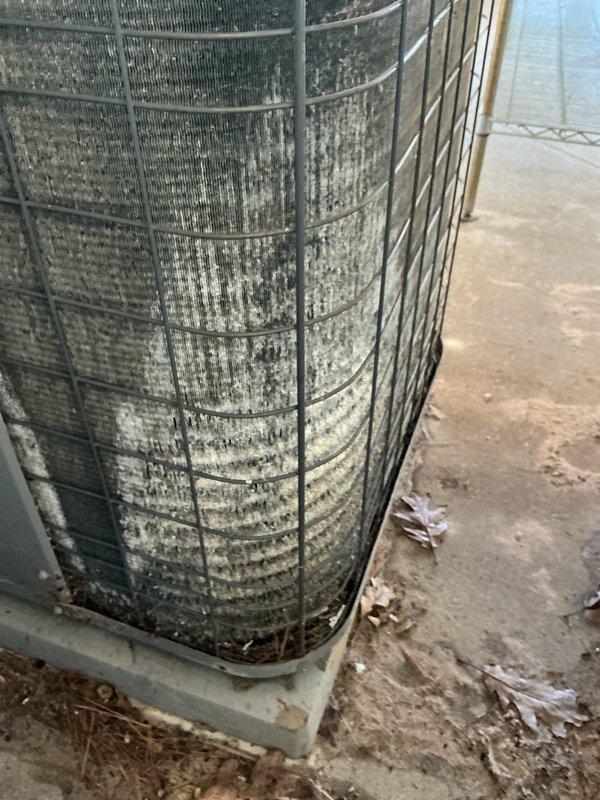 Completed annual cooling maintenance on two Heil AC systems, with the primary unit being 23 years old and the condensing unit dating to 2017. Performed comprehensive tune-up procedures including inspection of both outdoor condenser units, which showed significant dirt and debris accumulation on coil fins and protective mesh caging. Documented equipment condition with photographs showing heavy dust buildup and environmental residue on exterior surfaces, indicating extended exposure to outdoor elements without recent cleaning. Both units operational upon completion of maintenance procedures.