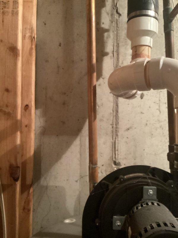 Conducted on-site assessment for water heater replacement on existing 6-year-old unit manufactured in December 2015. Documented current installation including copper supply lines, PVC venting configuration, and mechanical components in basement utility area. Provided customer with brand options and prepared estimate for replacement unit.